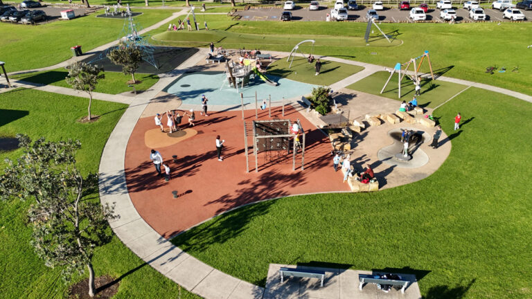 Aerial view of a park with playground and families inside