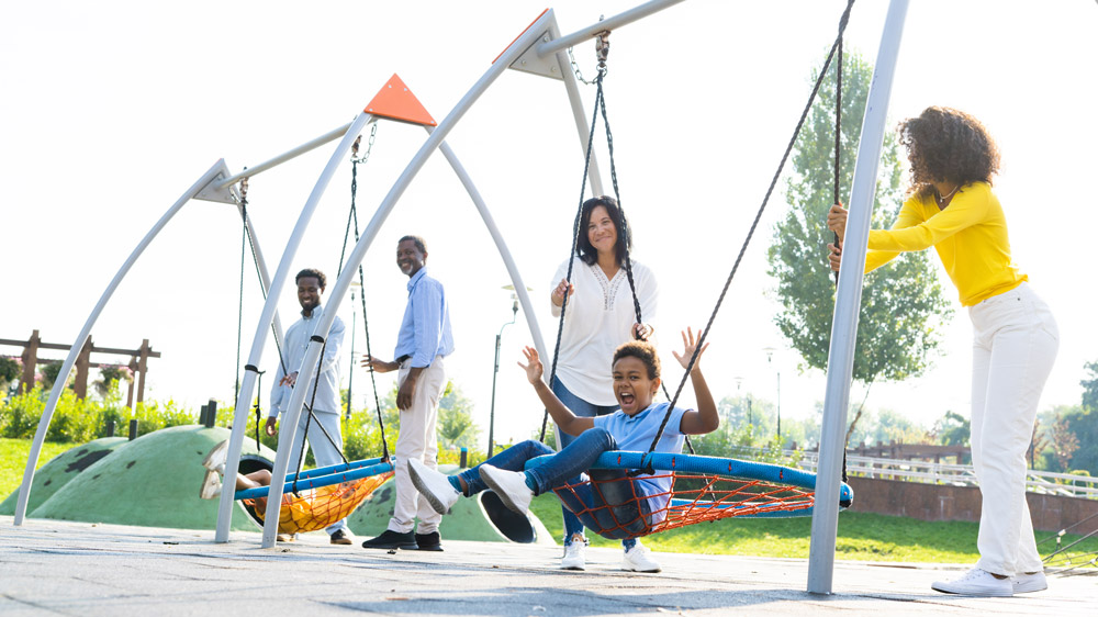 Happy African-American family in a park's playground