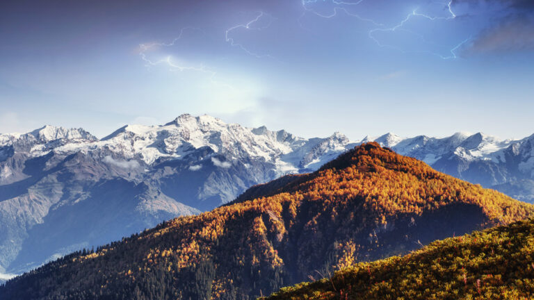 Fantastic mountain view with blue sky and lightning