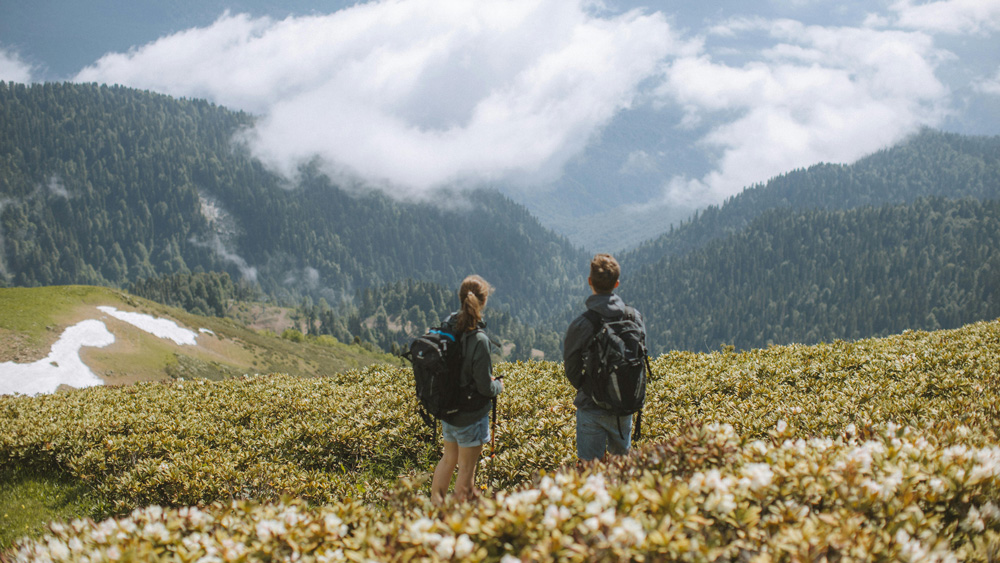 Two tourists watching perfect mountain view